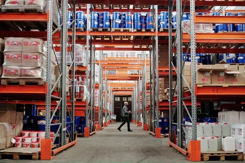 Costco warehouse aisle lined with bulk goods amid analysis of Q3 earnings, traffic, and membership growth