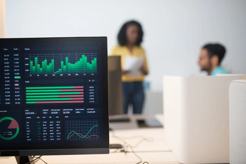 Financial trading screens representing Fed rate hike risk and stock market selloff